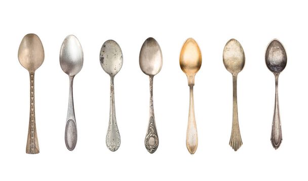 Top view of seven old silver beautiful tea spoons isolated on white background - Zdjęcie, obraz