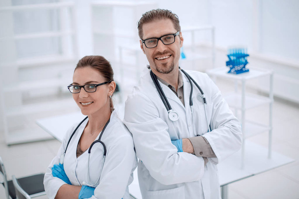 portrait of two young scientists on the background of the laboratory - Фото, зображення