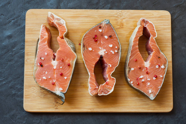 Steak raw red fish with lemon and spices dark background with copy space - Zdjęcie, obraz