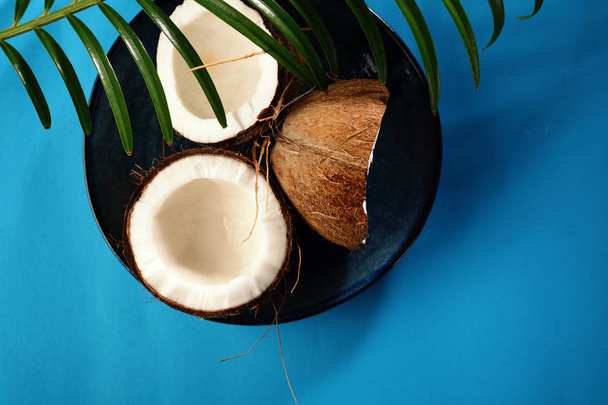 Fresh coconuts on blue background - Foto, afbeelding