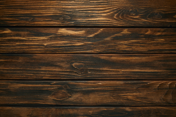top view of dark brown wooden background with horizontal planks - Photo, Image