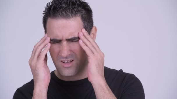 Face of stressed man having headache against white background - Footage, Video
