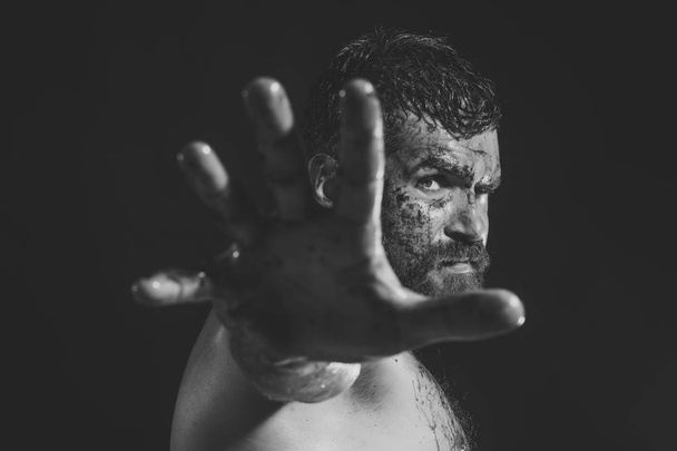 Man with bloody beard make stop gesture on black background - Фото, зображення