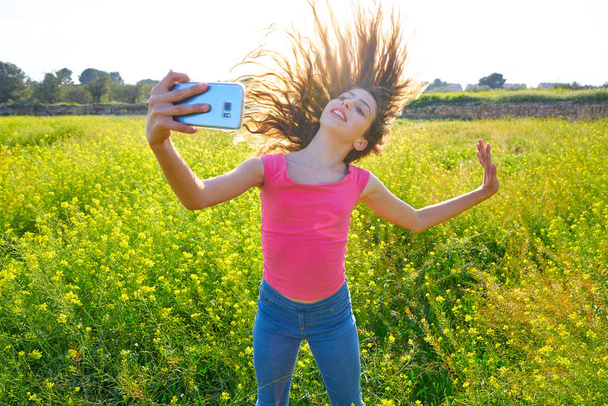 Teen girl selfie video photo in spring meadow moving hair - Φωτογραφία, εικόνα