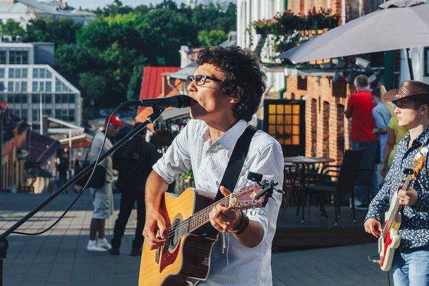 July 21, 2018 - Minsk, Belarus: man with guitar sings into microphone on street - Photo, Image