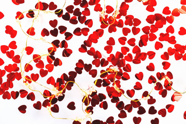 Heart shaped confetti and lights background. Passion, love and feelings St Valentine's celebration concept with copy space - 写真・画像