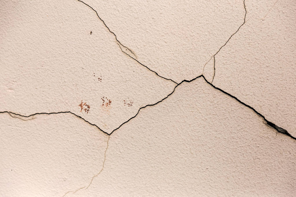 Cracks. Background surface with creative cracks. Web cracks as a background for creative design for a layout. Stone surface of the cement layer with a network of deep cracks. Anxious appearanc - Photo, Image