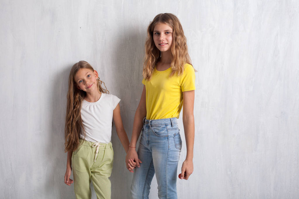 two girls hold hands fashion portraits healthy eating fruit - Fotografie, Obrázek