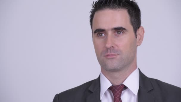 Face of handsome businessman thinking against white background - Felvétel, videó
