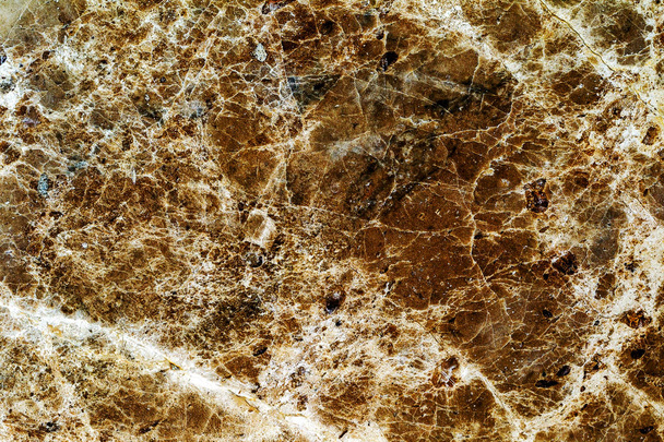 beautiful old yellow-brown decorative stone marble abstract cracks and stains on the surface as natural background - Photo, Image