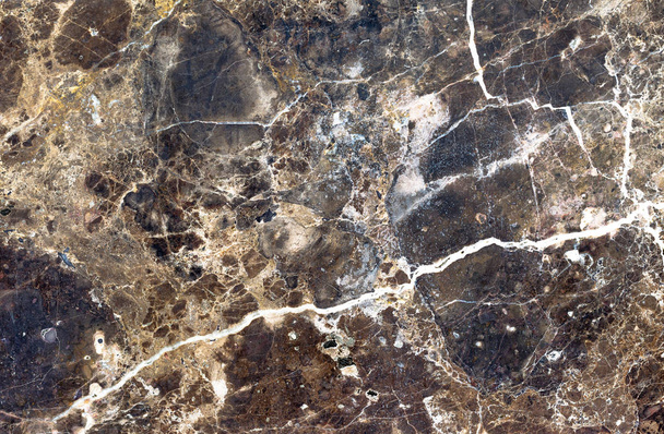 Brown natural marble . Beautiful multi-colored interior decorative stone marble abstract cracks and stains on the surface. - Photo, image