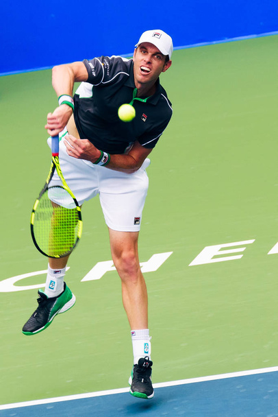 Sam Querrey of the United States serves against Guido Pella of Argentina in their first round match of the men's singles during the 2018 ATP Chengdu Open tennis tournament in Chengdu city, southwest China's Sichuan province, 25 September 2018 - Photo, Image