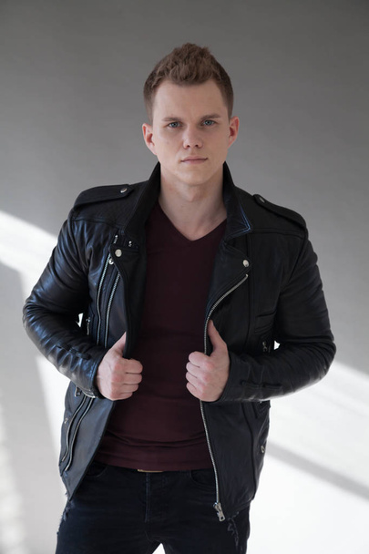 Portrait of a handsome young man in a black jacket - Photo, Image
