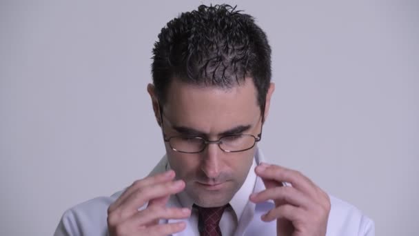 Handsome man doctor removing eyeglasses and looking at camera - Video
