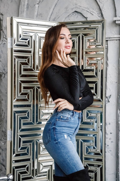 Portrait of beauty redhead woman in black blouse and blue jeans standing at luxury apartments interior   - Fotoğraf, Görsel
