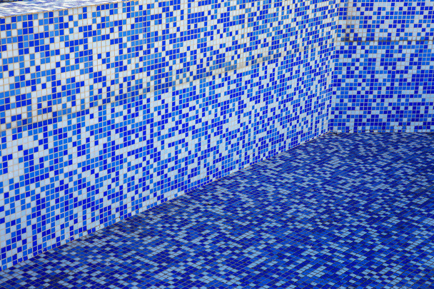 Blue modern blue background bottom of a swimming pool. Small glass tiles lined with rows of white tiles Venetian mosaic - Photo, Image