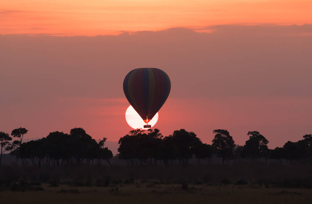 Big striped balloon on beautiful sunset background - Фото, изображение