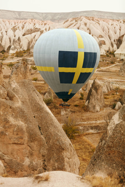 Travel. Hot Air Balloon Flying Above Rock Valley, Ballooning In Cappadocia Turkey. High Resolution - Фото, изображение