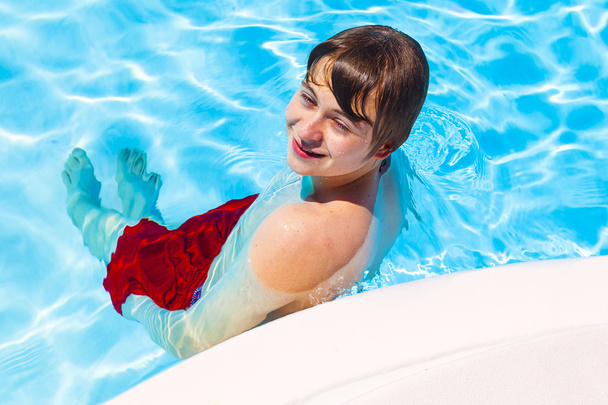 cute handsome teenage boy rests the pool - Foto, Imagem