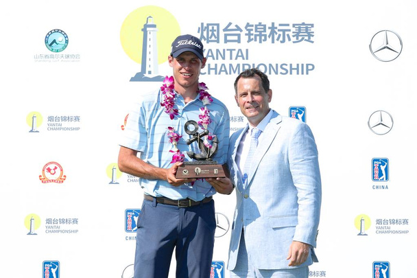 American golf player Joseph Winslow poses with the champion trophy during the Yantai Championship, the seventh event on this season's PGA TOUR Series-China in Yantai city, east China's Shandong province, 15 July 2018 - Fotó, kép