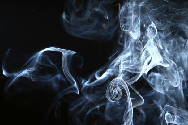 marvellous flowing contrast blue smoke on heavy black background. - Foto, afbeelding