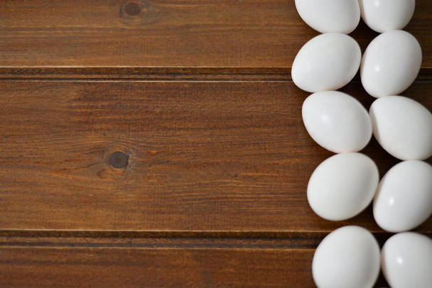 white eggs on wooden plate on wooden background , copy space  - Photo, image