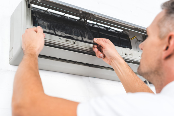 close up view of man fixing filter of air conditioner  - Fotó, kép