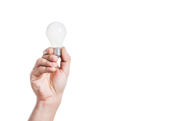 cropped view of man holding light bulb isolated on white, energy efficiency concept - Fotó, kép