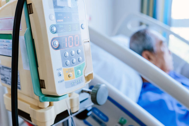 医療、病院のベッドで高齢患者の輸液ポンプのイメージ - 写真・画像