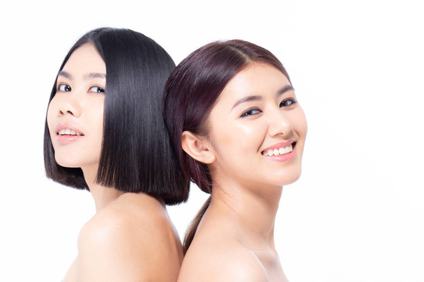 Two beautiful asian women portrait. Beautiful women looking to camera. People with youth and skin care concept isolated on white background. - 写真・画像
