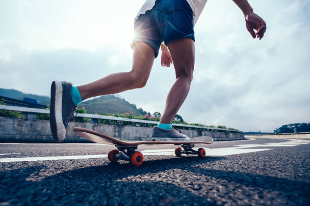 Skateboarder skateboarding on highway road - Fotó, kép