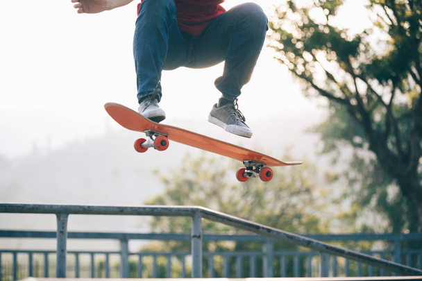 Cropped shot of skateboarder skateboarding at skatepark - Fotó, kép