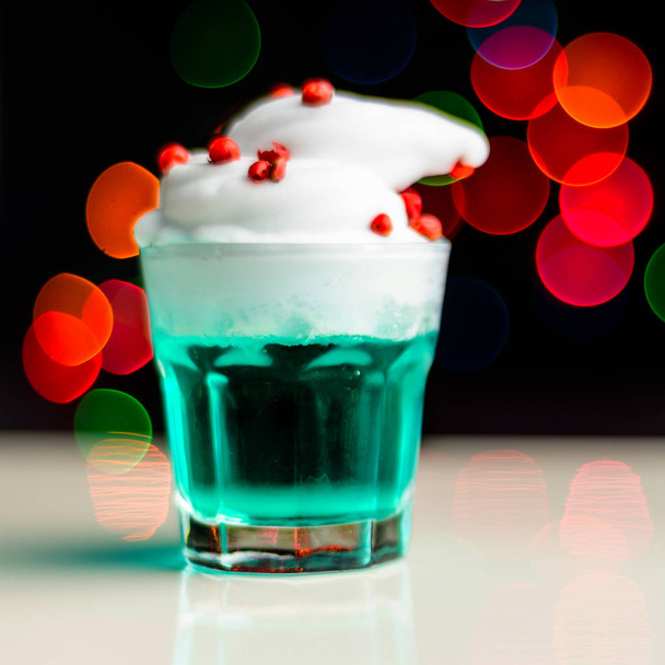 Christmas drink shot in a shot glass on a bokeh background, Christmas decoration on the bar, xmas party - Foto, Imagem