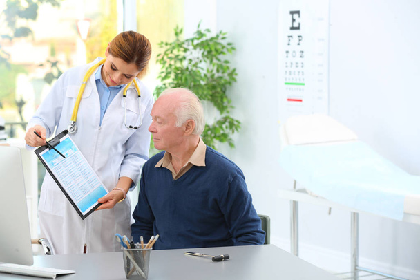 Doctor working with elderly patient in hospital. Space for text - Photo, Image