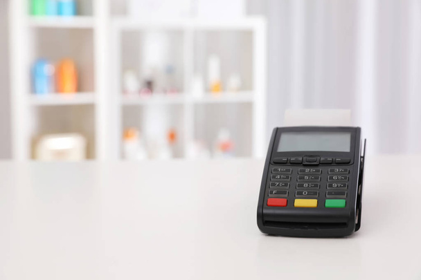 Payment terminal on counter in pharmacy. Space for text - Φωτογραφία, εικόνα