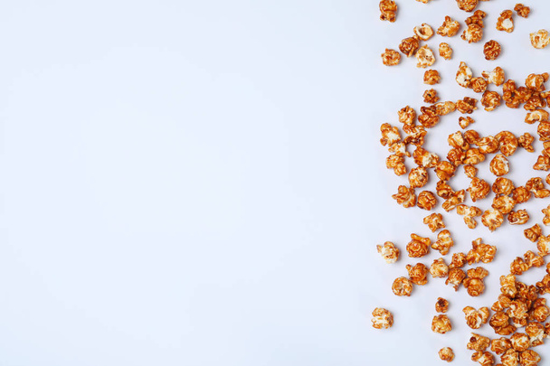 Flat lay composition with caramel popcorn and space for text on white background - Valokuva, kuva
