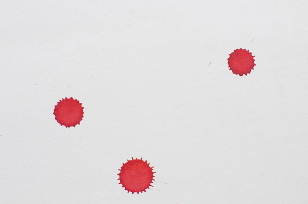 closeup view of paint red dots over rustic white cardboard background - Fotó, kép