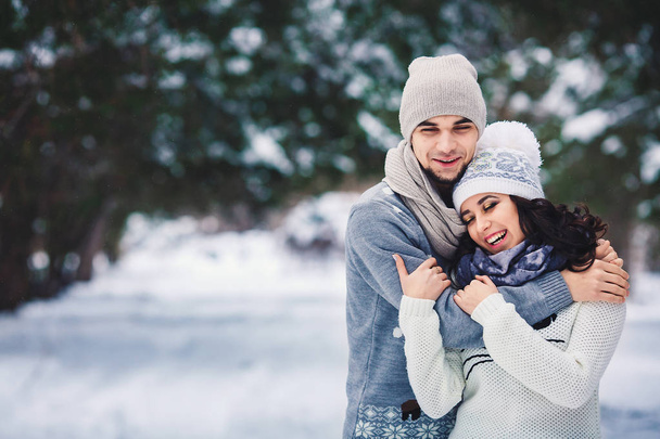 man and girl in sweaters hugging in the park in winter - Photo, Image