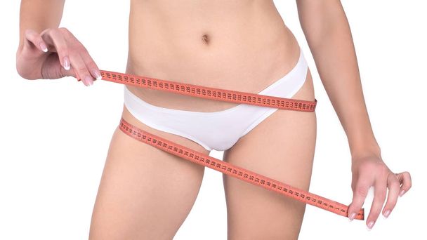 Slim fit female hips with measuring tape, isolated on white - Foto, immagini