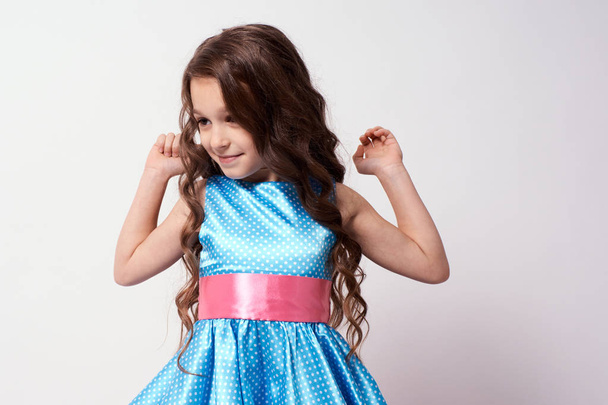 Beautiful little girl. Blue dress. White background. - Foto, Imagen