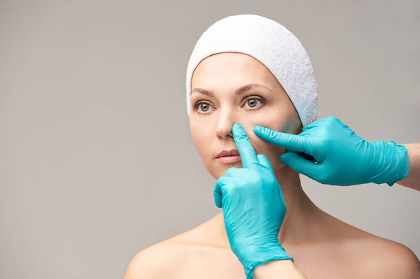 Derma rejuvenate treatment. Cosmetology face surgery. Anti wrinkle exam. Woman and doctor glove hands. - Fotoğraf, Görsel
