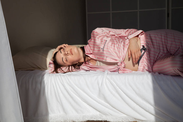 woman in pink Pajamas fashionable portrait bedroom - Fotografie, Obrázek