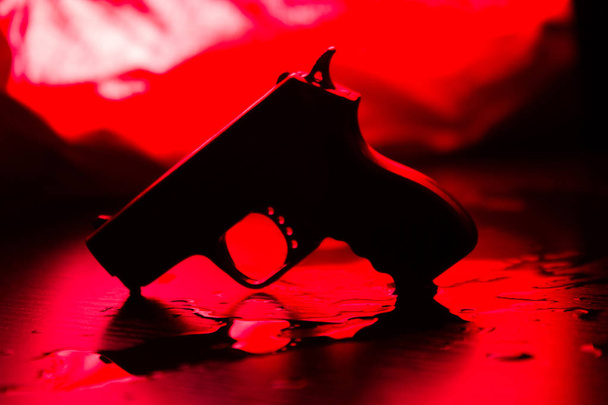 High contrast image of a bloody crime scene with gun on the floor - Φωτογραφία, εικόνα