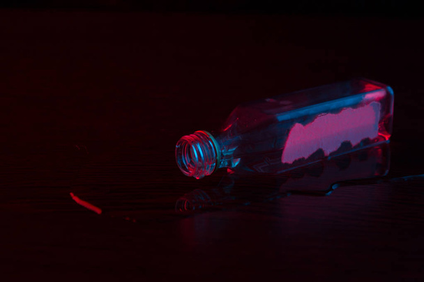 Steaming bottle of poison in neon light. copy space - Zdjęcie, obraz