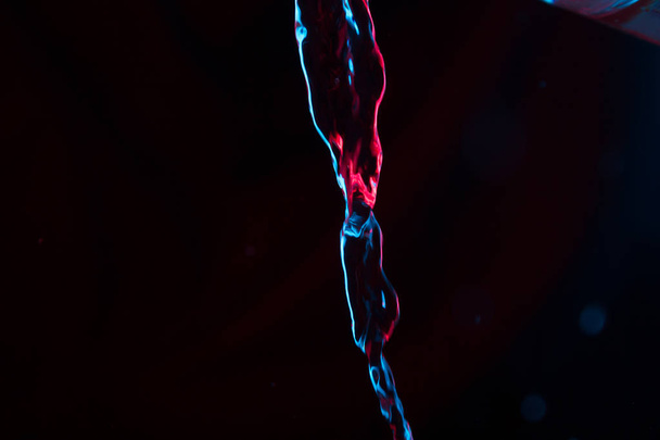 Red and blue neon background from water flow. defocused - Zdjęcie, obraz