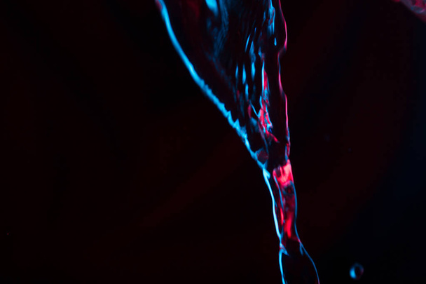 Red and blue neon background from water flow. defocused - Φωτογραφία, εικόνα