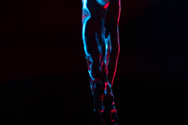 Red and blue neon background from water flow. defocused - 写真・画像
