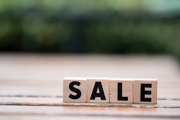 Wooden blocks with the word sale. Concept of sales and seasonal sales of goods and services. Discounts and promotions. Place for text. - Foto, Imagem