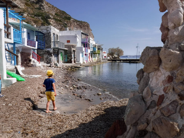 Rear view of boy walking on Milos island, Greece - Photo, Image