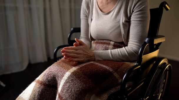 Disabled nervous female clenching hands, feeling lonely and helpless, wheelchair - Фото, зображення
